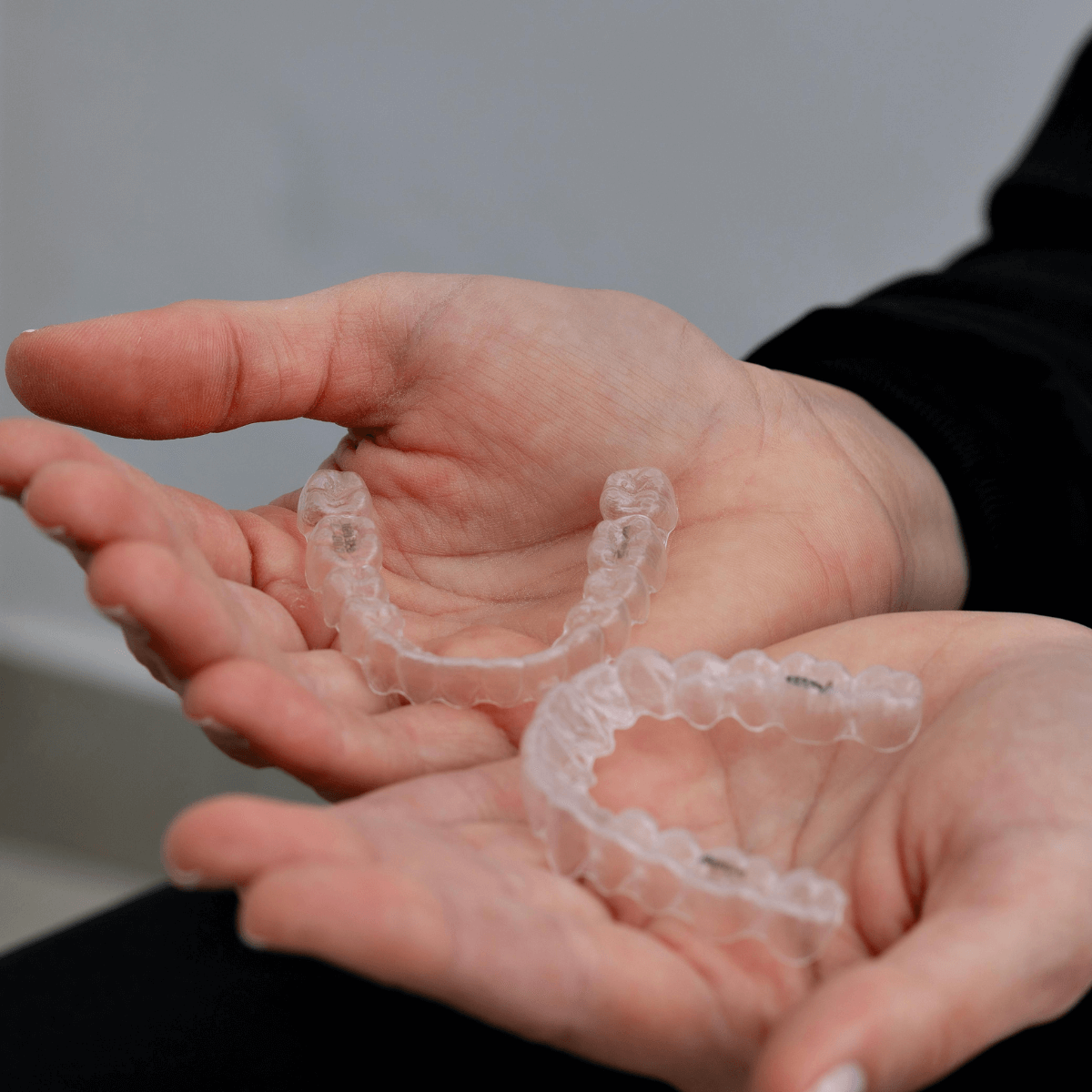 someone holding clear aligners at heaton mersey orthodontic centre